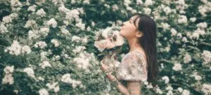 woman standing near flowers