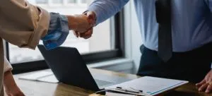 Man and woman shaking hands.