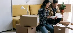 A couple packing for moving abroad