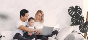 A family looking using a laptop to research property types in Hong Kong.