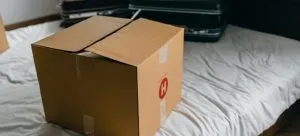Packing box on the bed with suitcases.