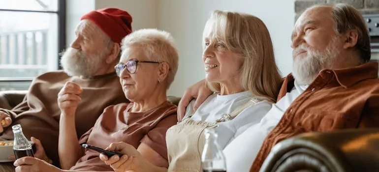 A group of elderly people sitting on a sofa