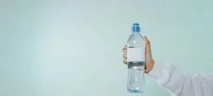 A person holding a bottle of water.