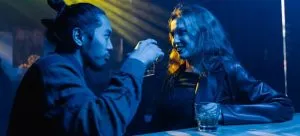 Two people in a bar on a date. Bars are common places in Lan Kwai Fong which is one of the best places for singles in Hong Kong.