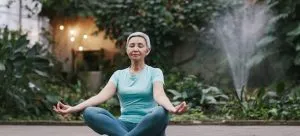 A woman doing yoga which can be one of the activities for seniors when moving to Hong Kong during the retirement.