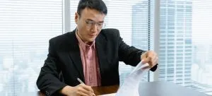 A man signing a contract.