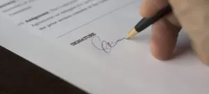 A man signing a contract.