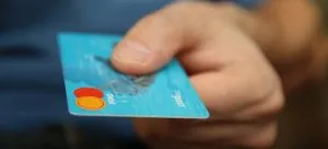 A person holding a debit card.
