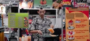 A man serving food on a market.