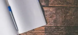 A notebook and a pen are useful to write a plan, so you can have a smooth international move with your family.