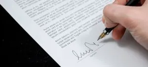 Signing a document.