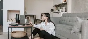 A woman using a laptop and doing research which is important when you want to move from HK to Washington DC.